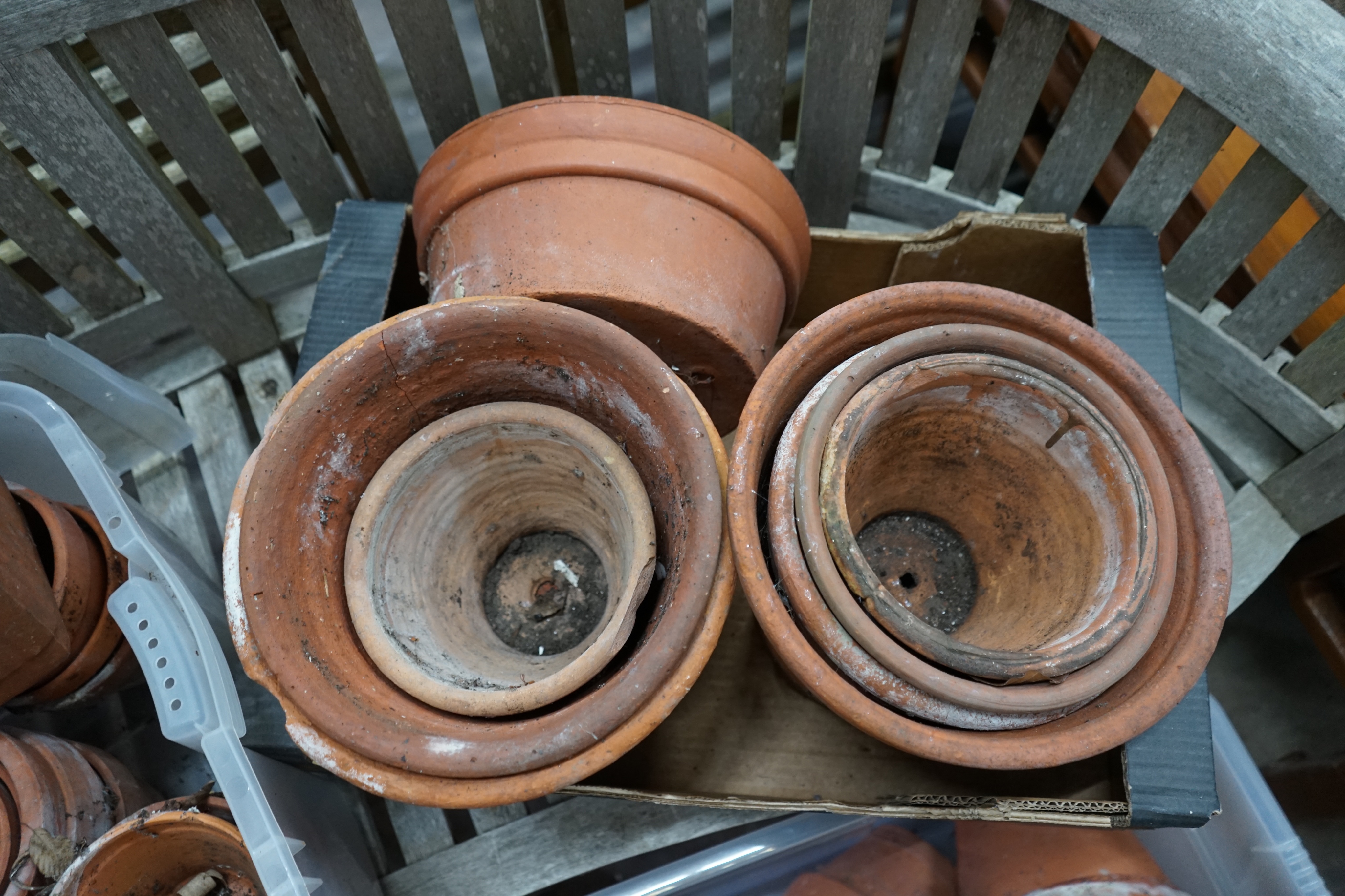 Approximately 100 terracotta garden pots, largest diameter 33cm height 28cm